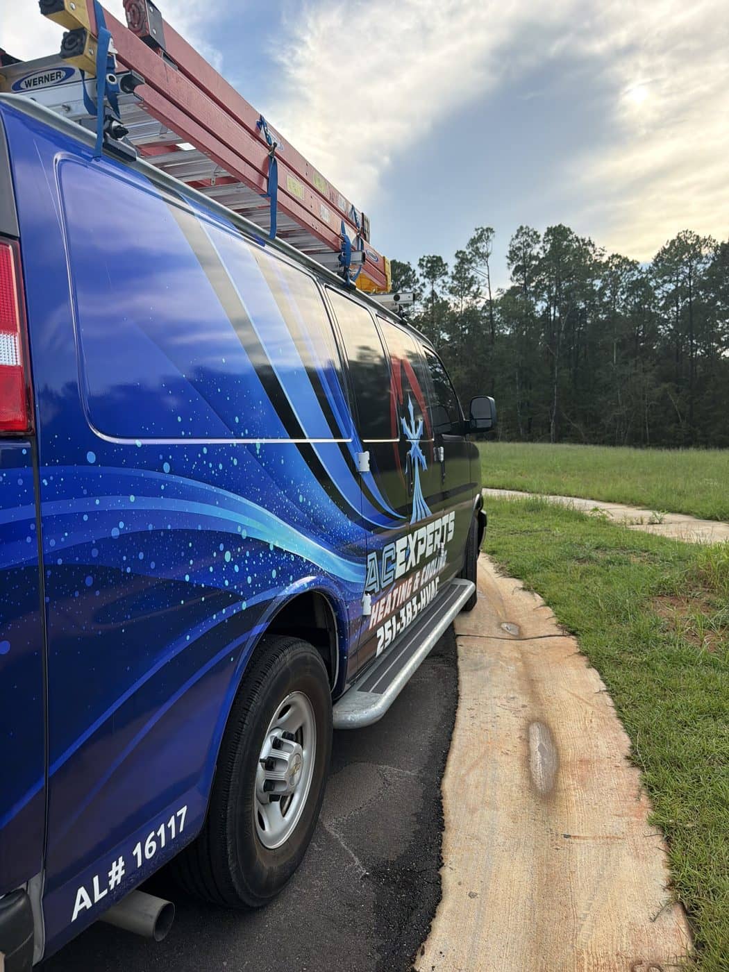 ACExperts service van with Alabama HVAC licence number 16117 on the rocker panel