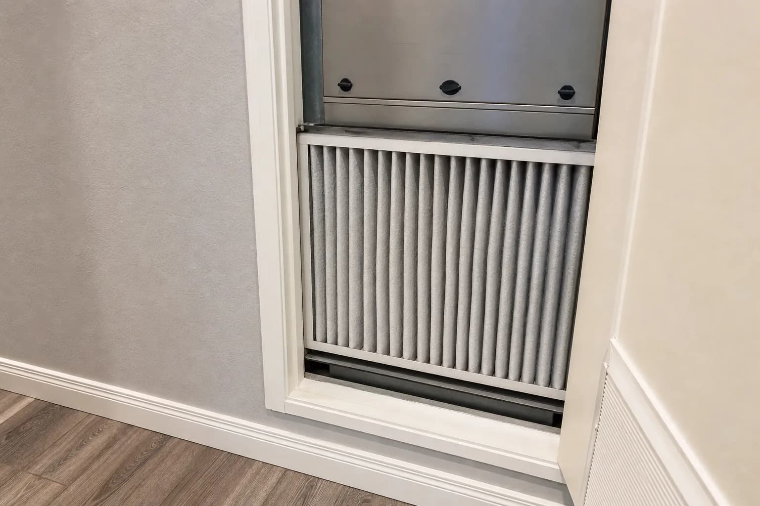 Indoor air-quality equipment in a Foley home hallway, fresh-filter view