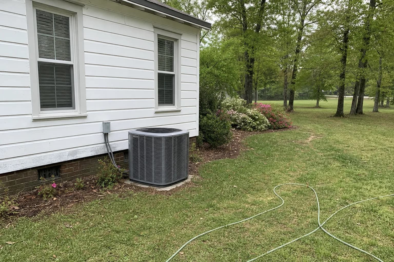 AC unit being maintained at a Bay Minette inland Baldwin County home, pad view, spring