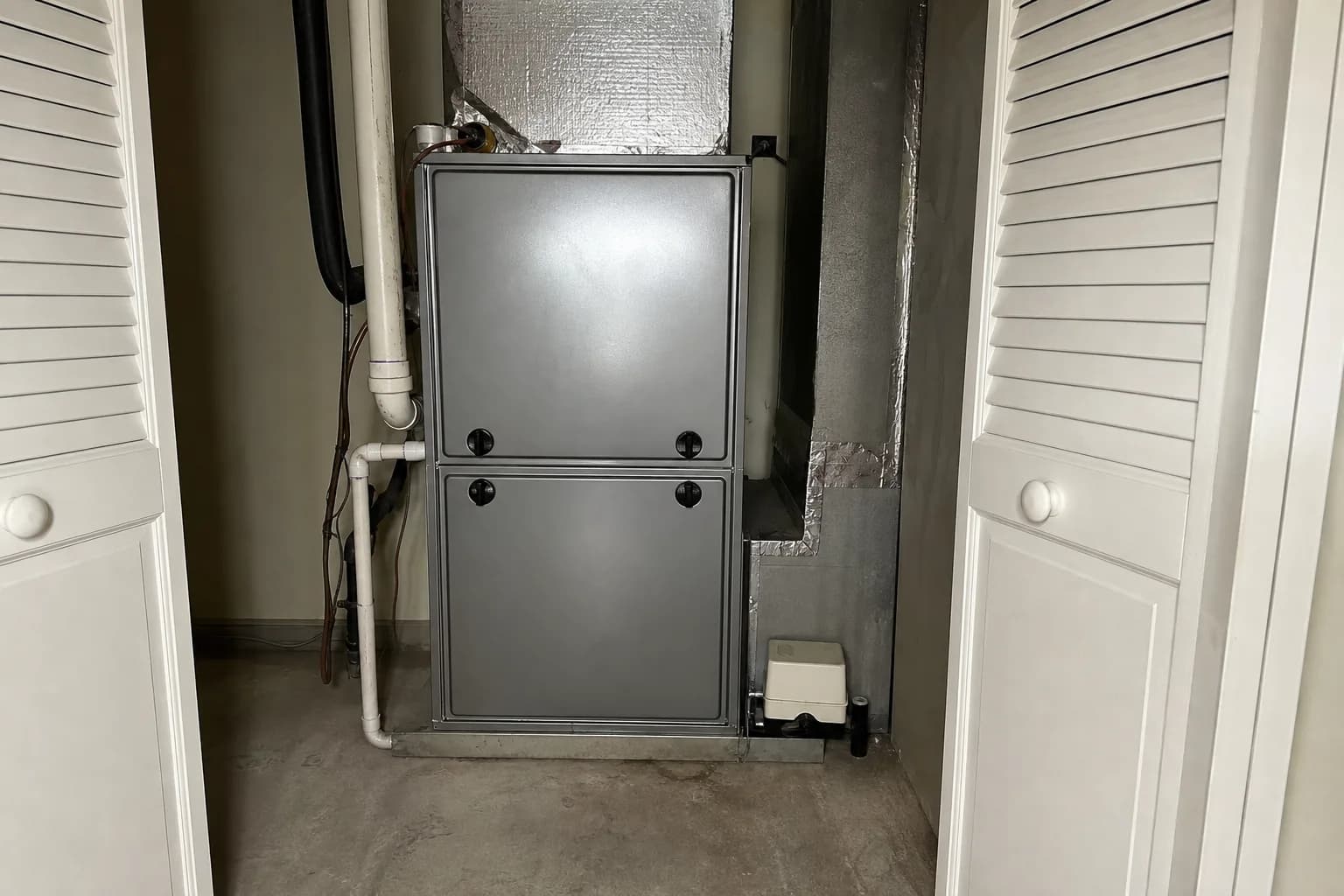Indoor air handler being serviced in a Baldwin County home utility closet, routine check