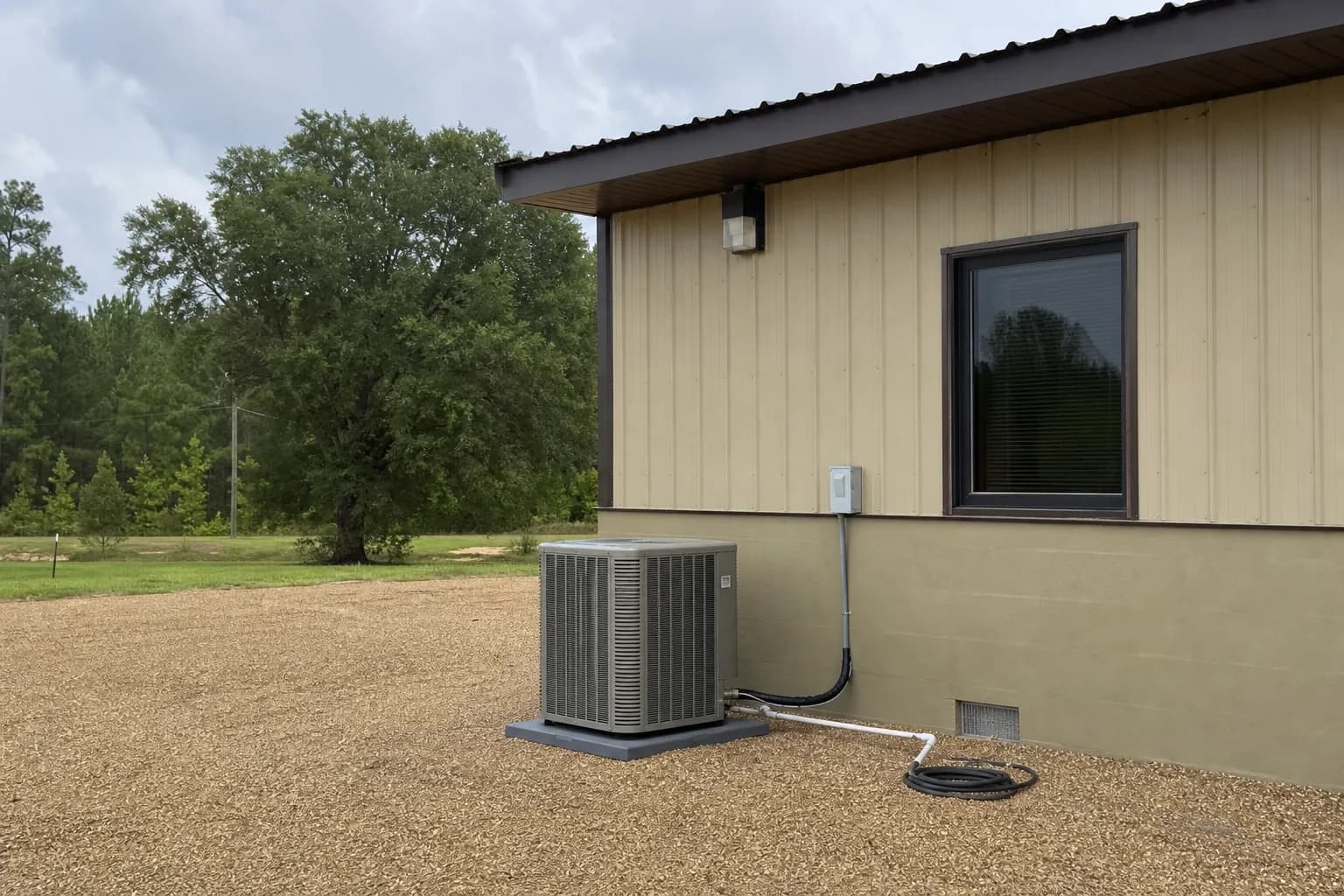 Newly installed AC condenser at a Robertsdale inland Baldwin County home, pad view, summer