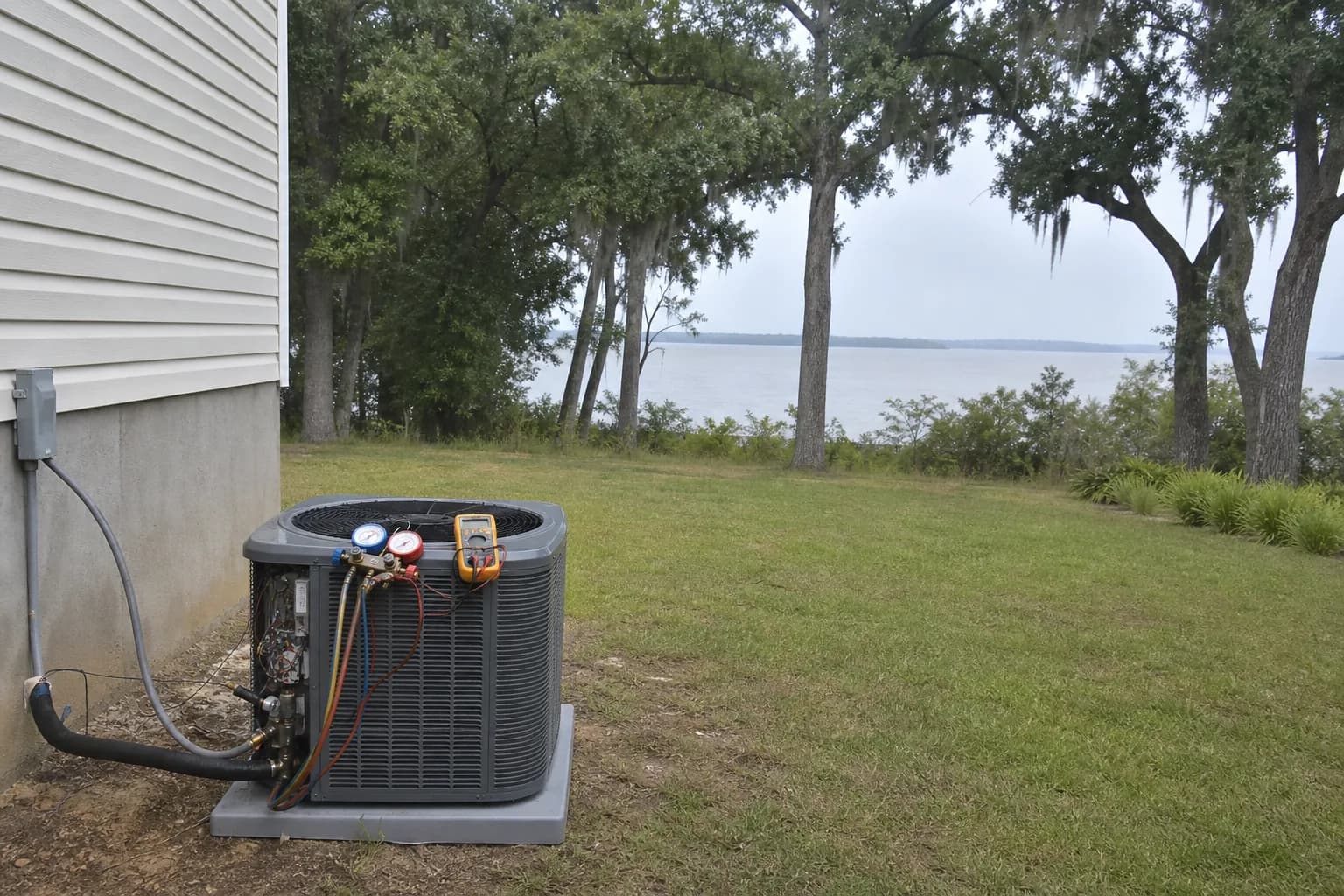 AC condenser being serviced at a Daphne Mobile Bay home, routine check, summer