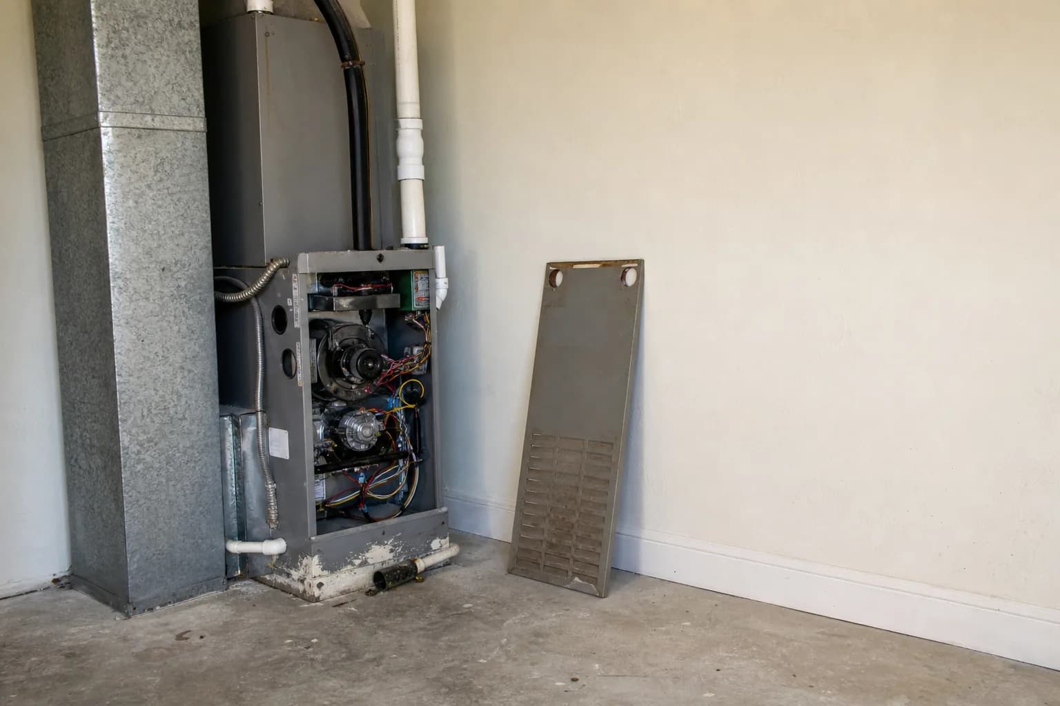 Gas furnace being serviced in a Fairhope home interior wall, tune-up view