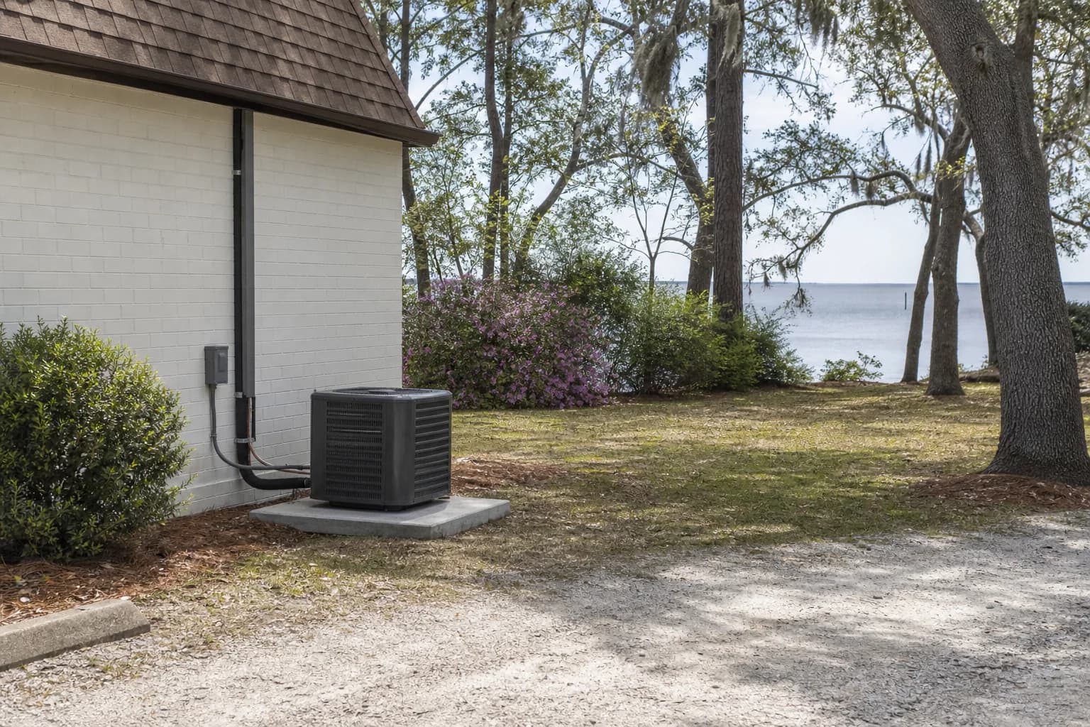 Newly installed AC condenser at a Fairhope Mobile Bay home, backyard view, spring
