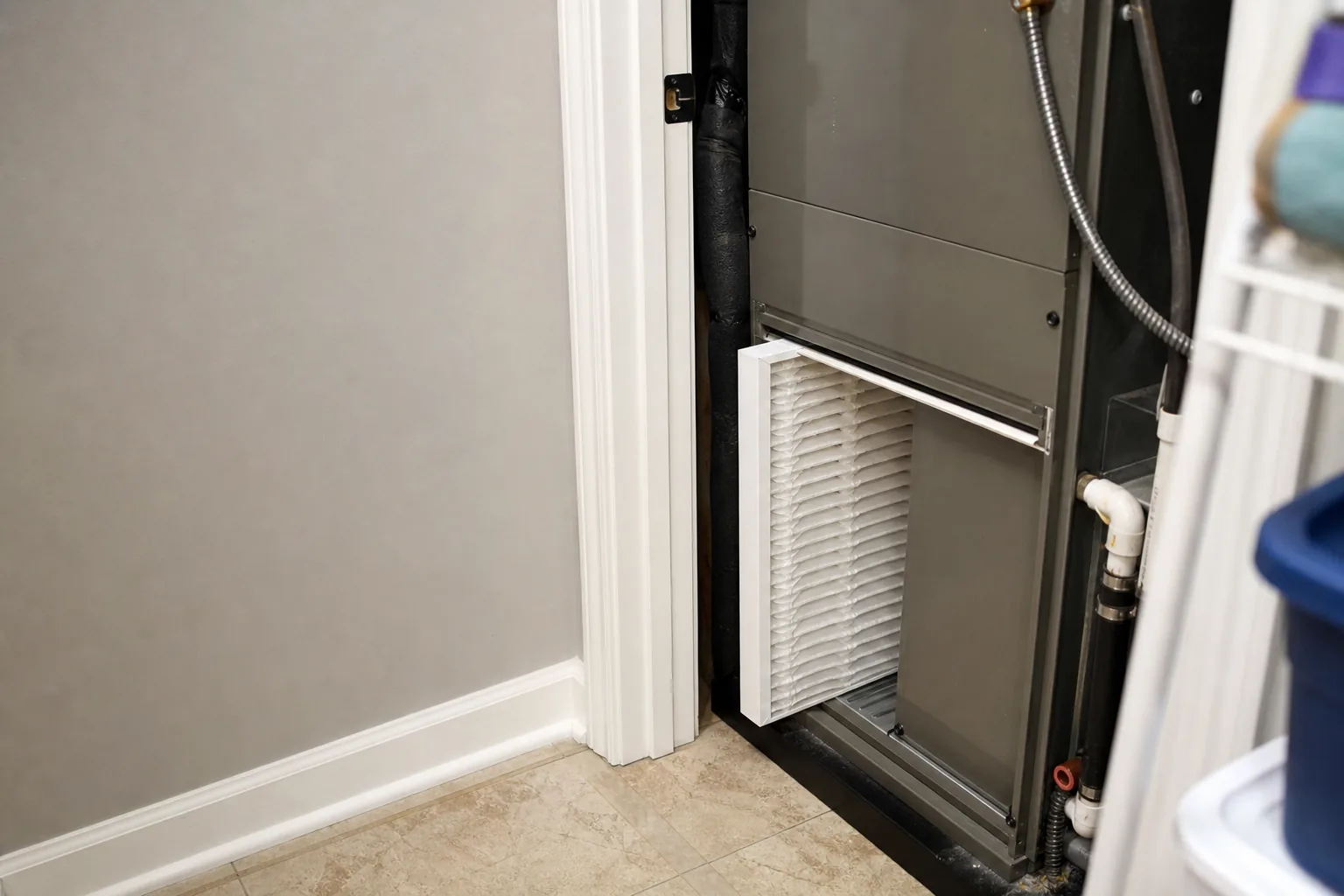 Indoor air handler and filter in a Fort Morgan home utility closet, service view