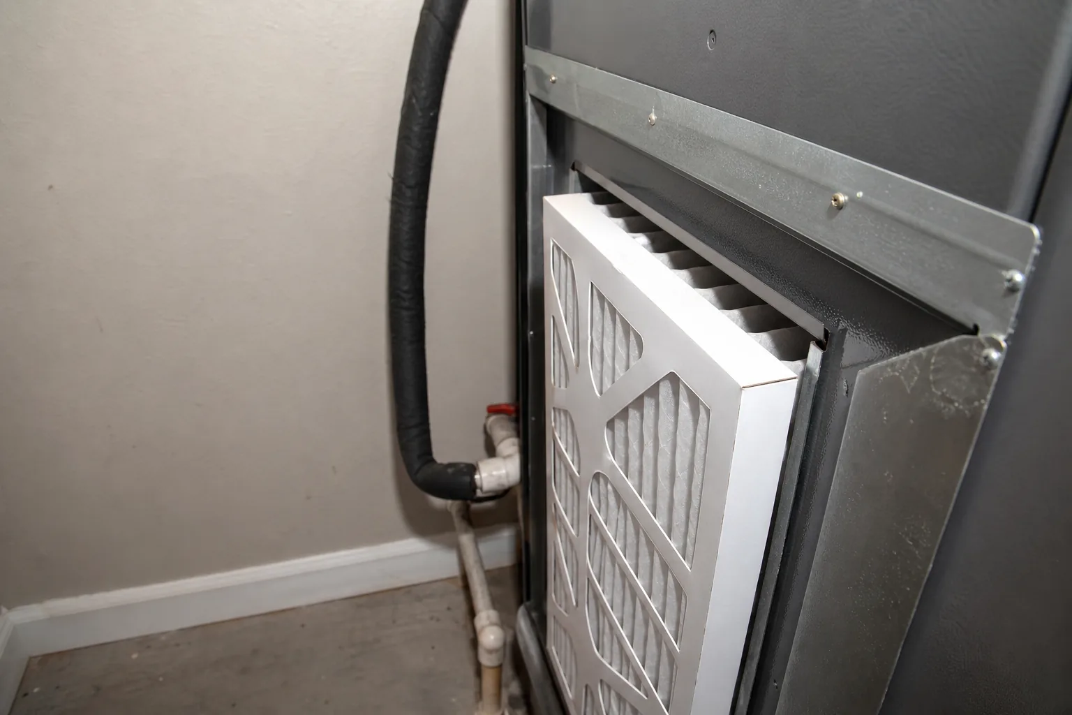 Indoor air handler and filter in a Foley home back room, install detail