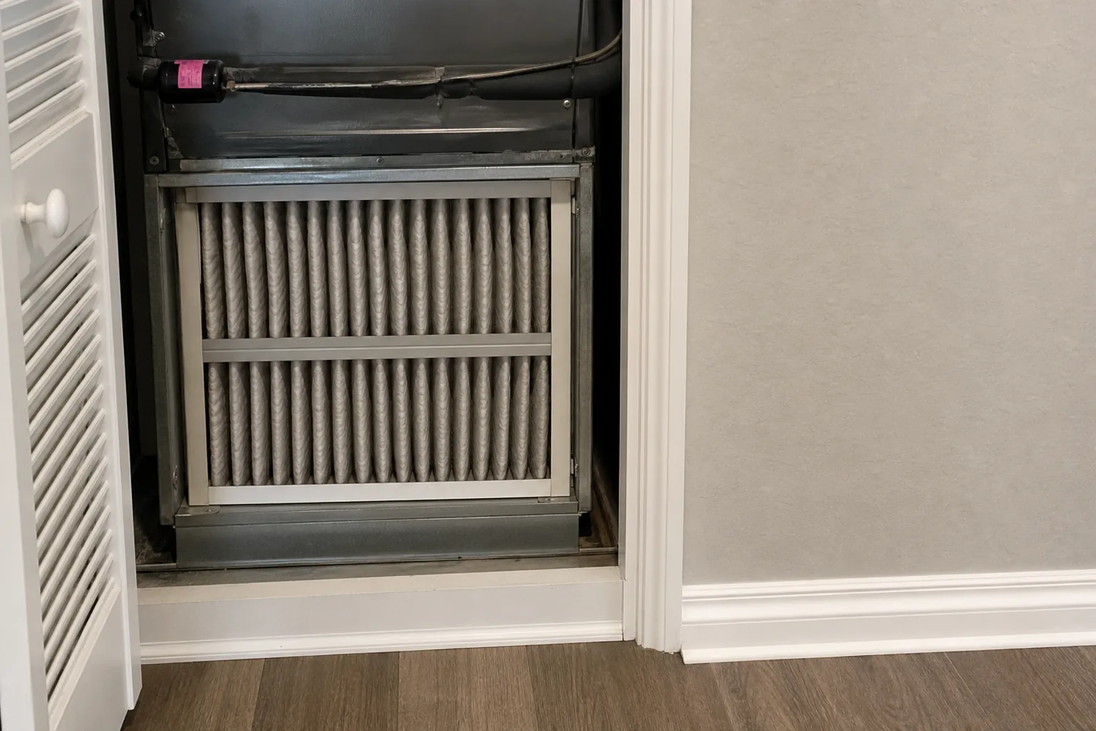 Indoor air-quality equipment in a Magnolia Springs home interior wall, fresh-filter view