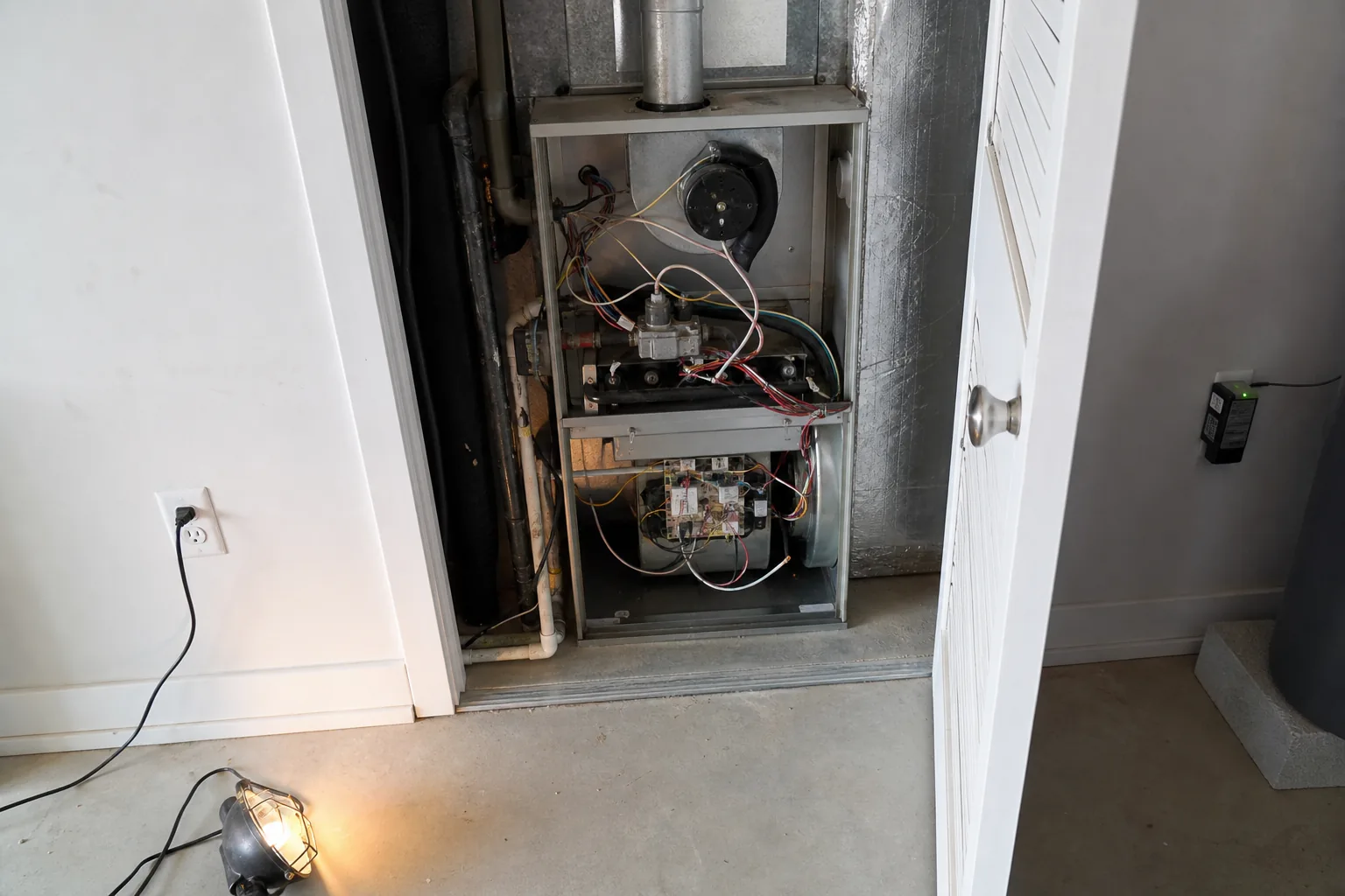Indoor HVAC unit on an after-hours call in a Spanish Fort home garage, access-panel view
