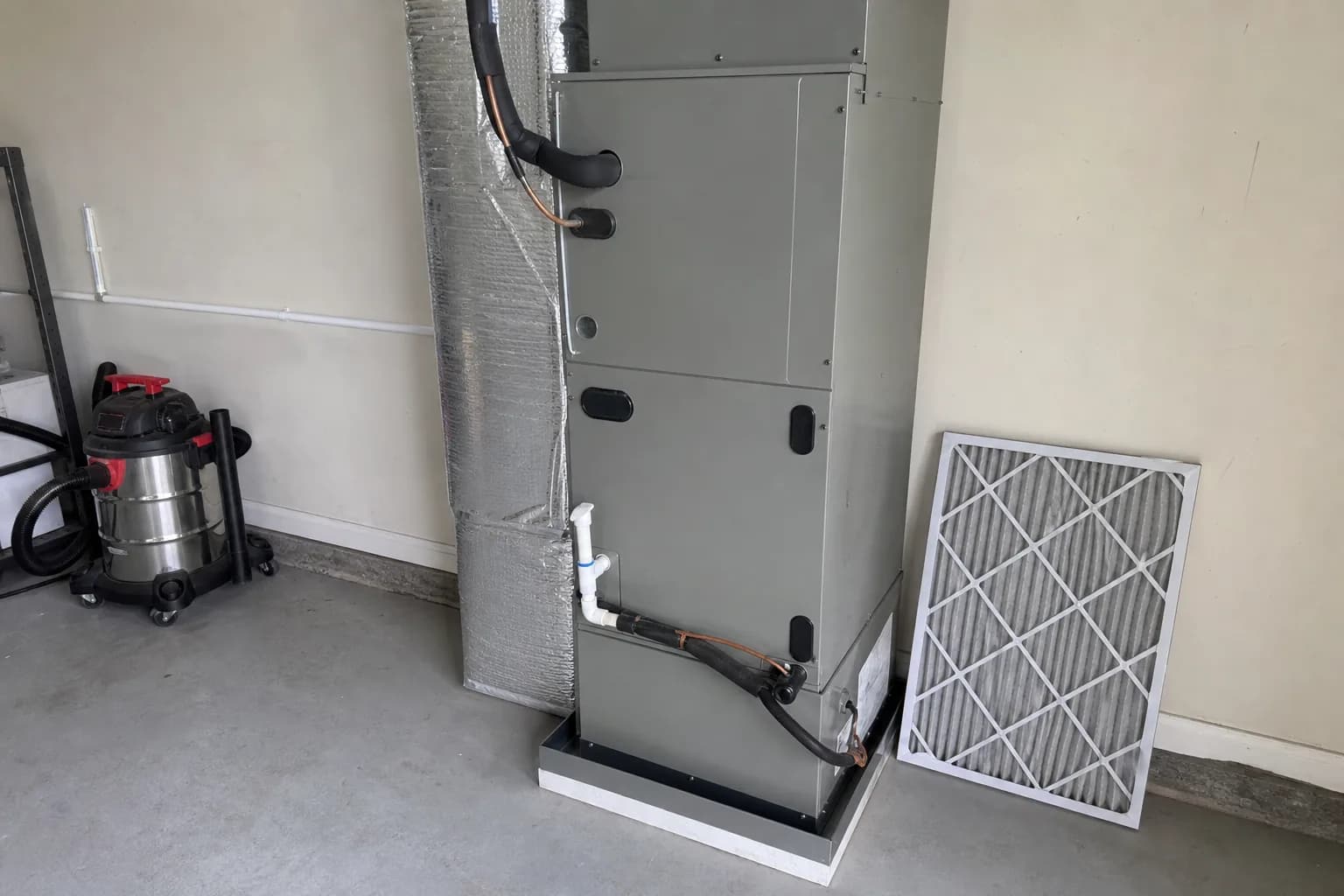 Indoor air handler and filter in a Stockton home mechanical room, tune-up view