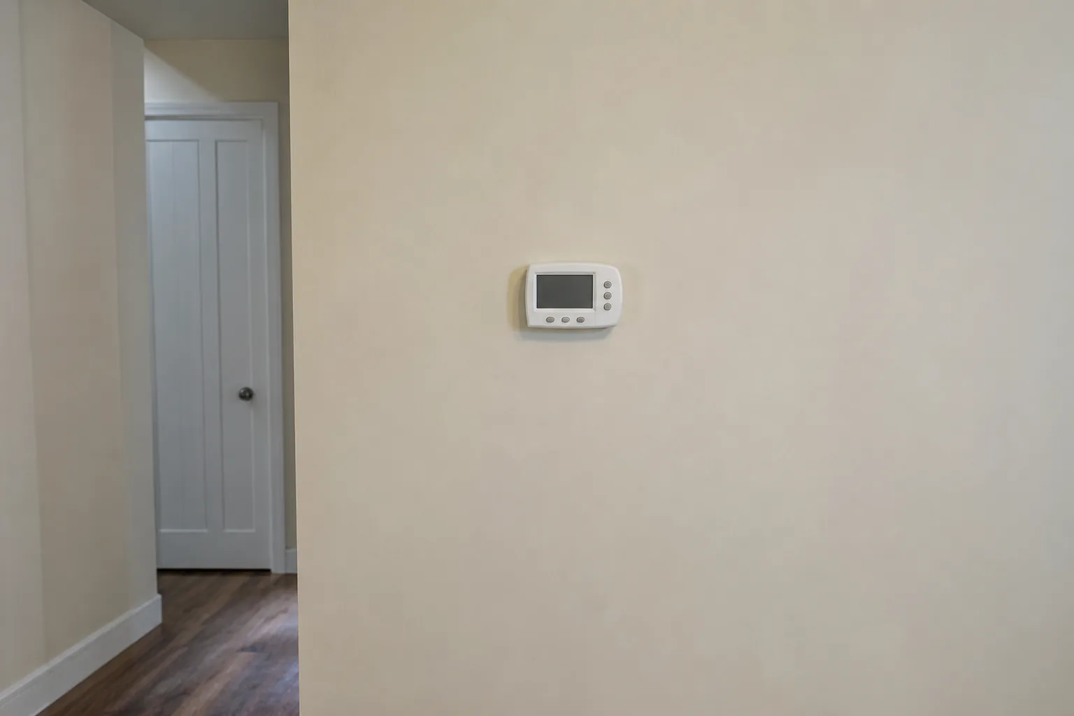 Indoor HVAC unit on an after-hours call in an Orange Beach home interior wall, maintenance view