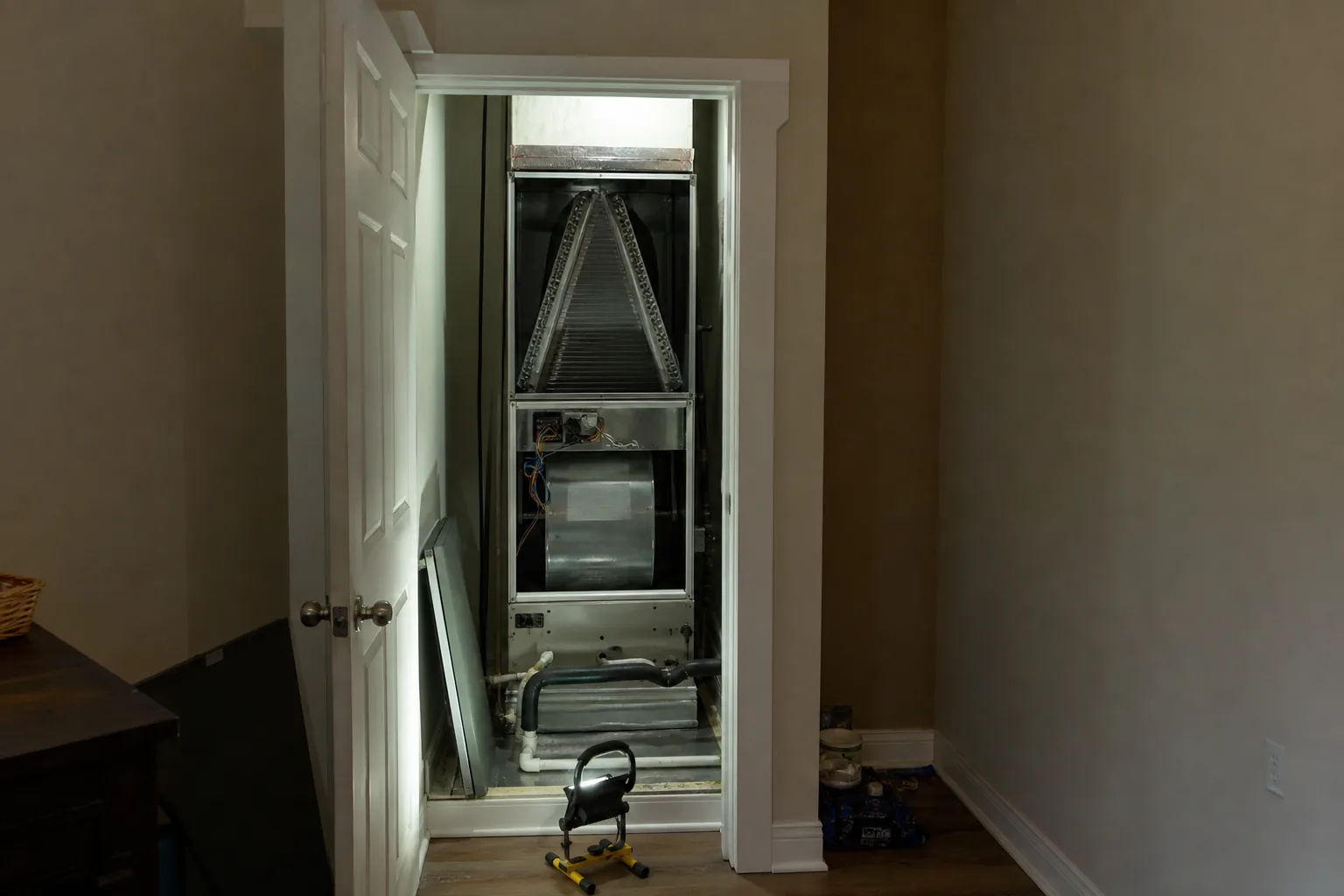 Indoor air handler being serviced in a Silverhill home utility closet, service view