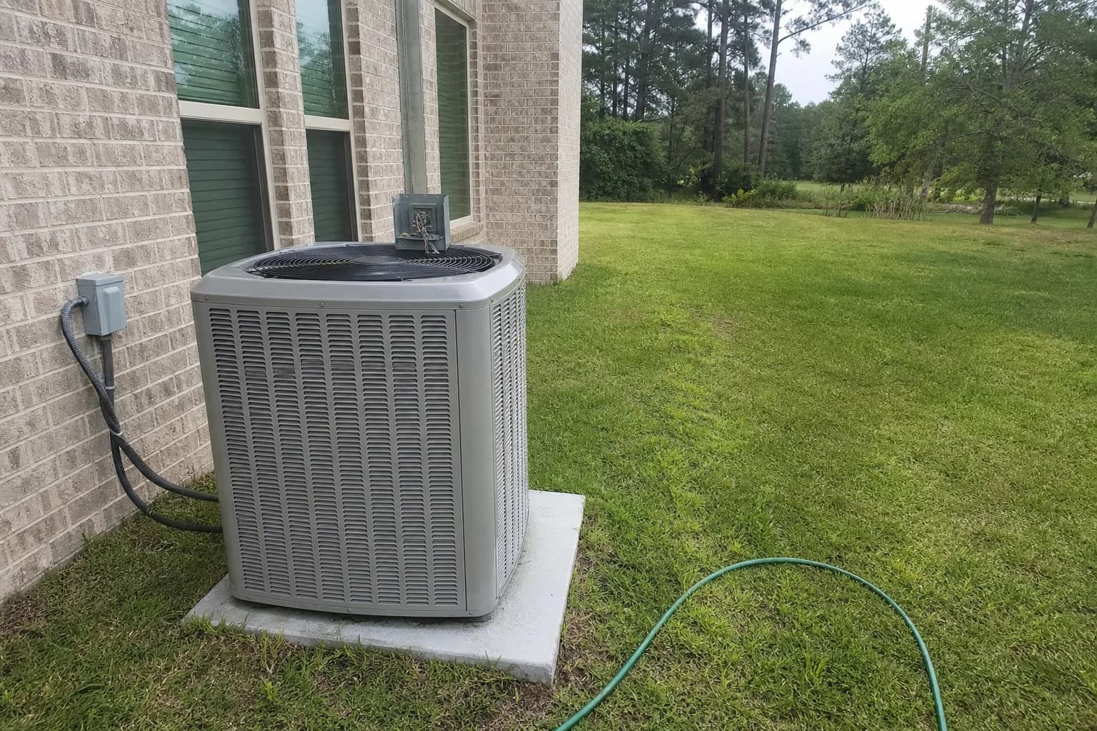 HVAC unit on an after-hours call at a Robertsdale inland Baldwin County home, disconnect view, summer