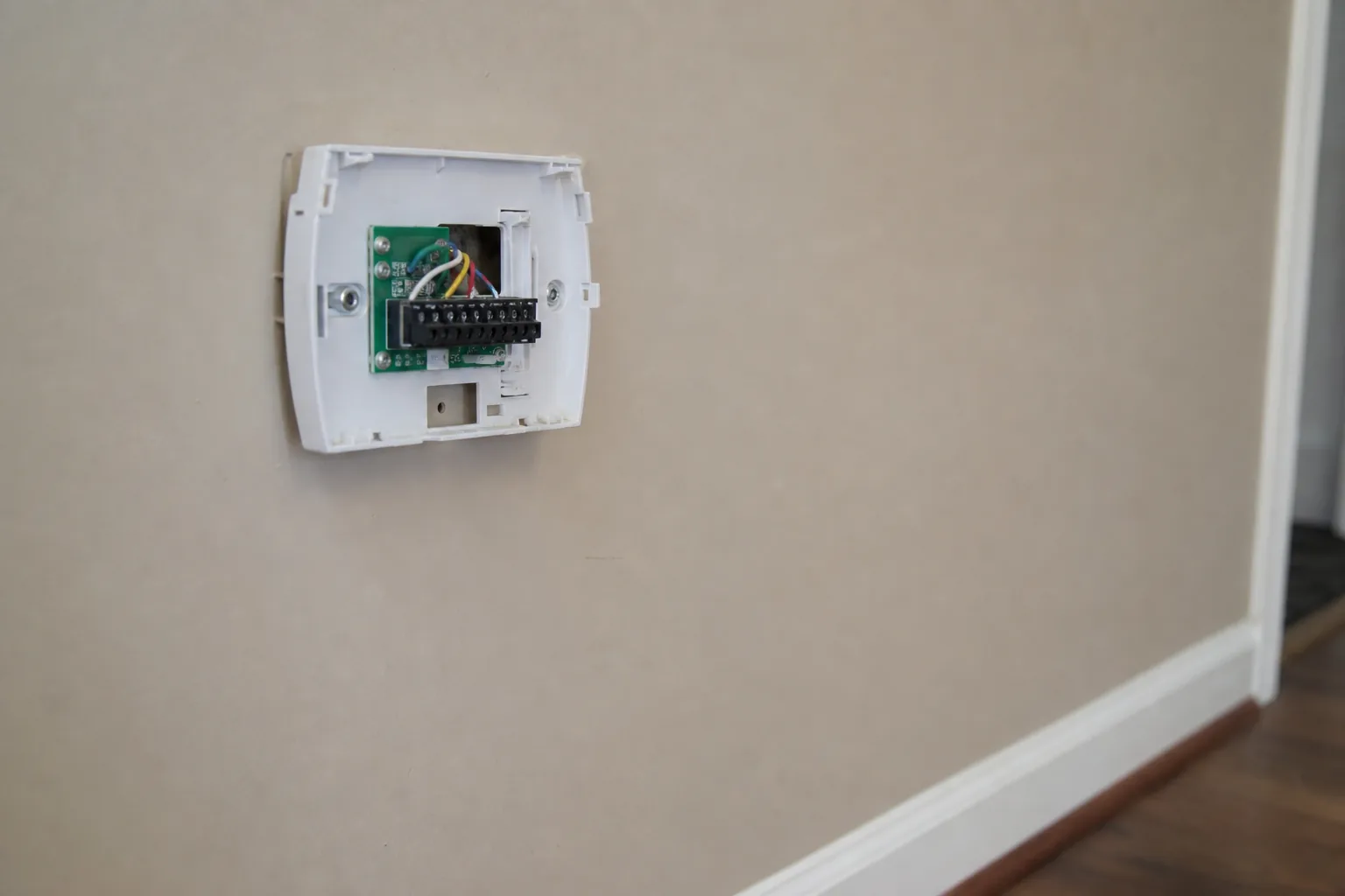 Gas furnace being serviced in a Daphne home hallway, panel off