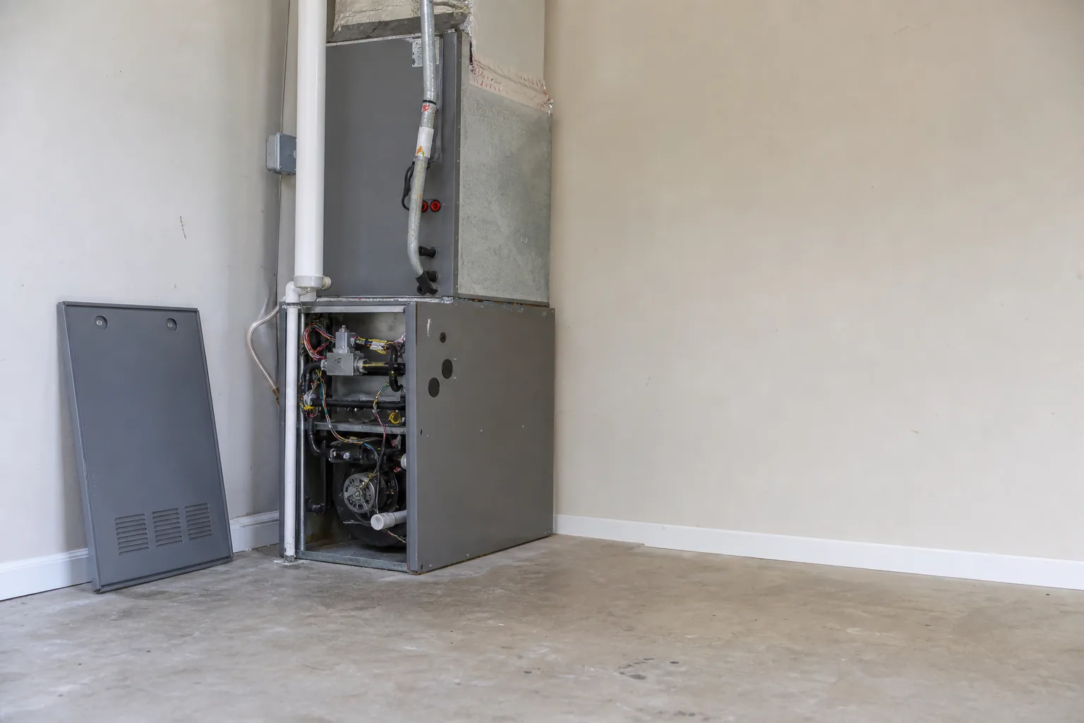 Gas furnace being serviced in a Fairhope home mechanical room, comfort-control view