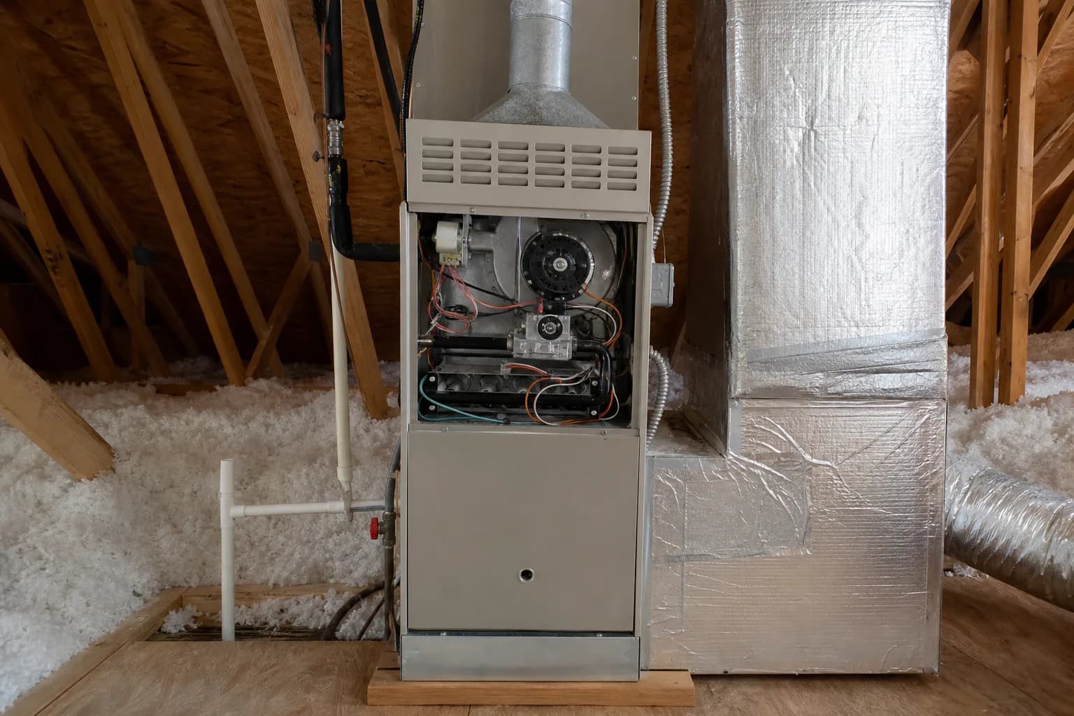 Indoor HVAC unit on an after-hours call in a Loxley home attic, duct detail
