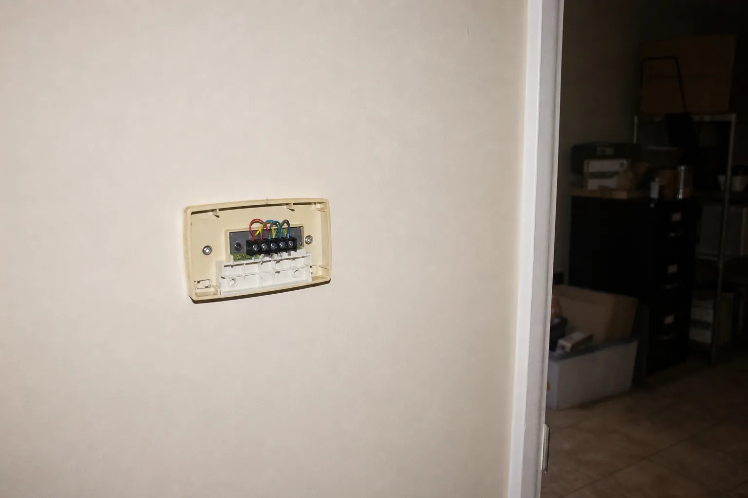 Indoor air handler being serviced in a Bay Minette home back room, close-up