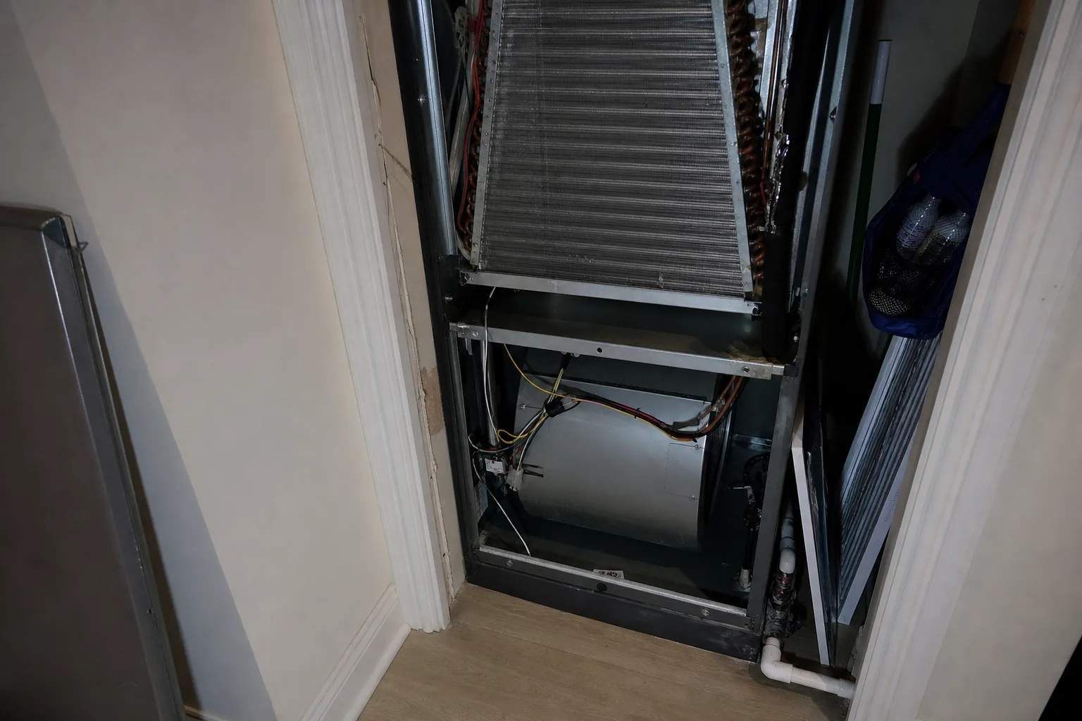 Indoor air handler being serviced in a Gulf Shores home mechanical room, panel off