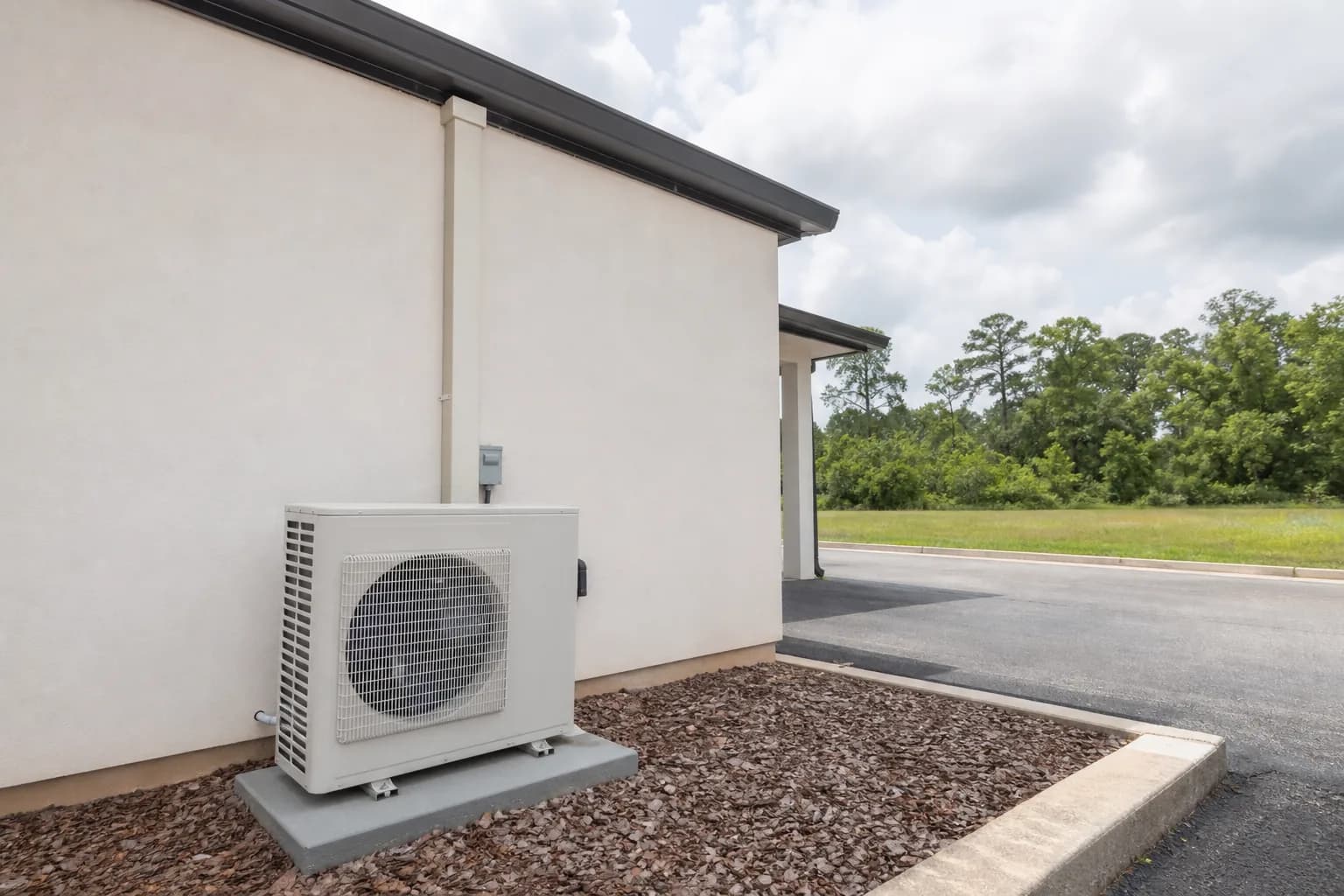 Home heat pump unit at a Bay Minette inland Baldwin County home, fan-grille detail, summer
