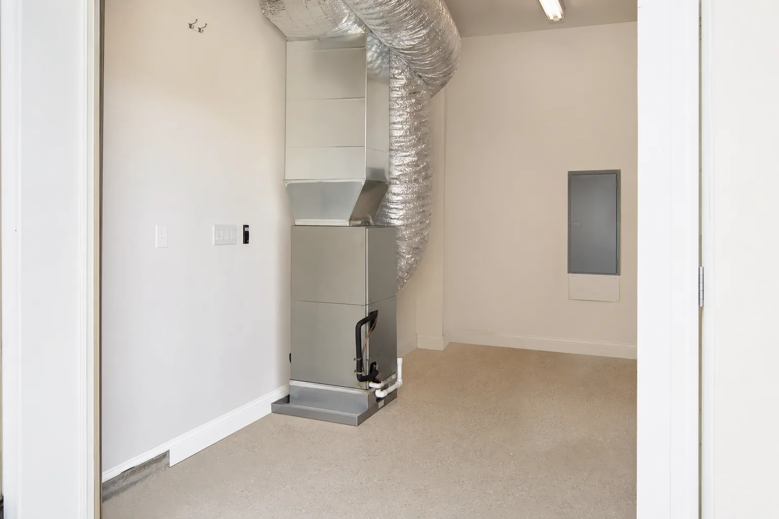 Newly installed indoor air handler in a Foley home back room, panel off